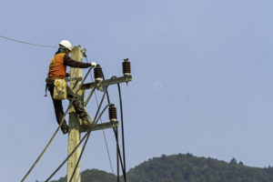 Electric worker on pole installing new cable