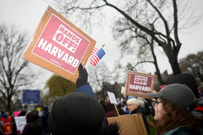 FILE PHOTO: Demonstrators rally on Cambridge Common in a protest organized by the City of Cambridge against interference by the federal government, in Cambridge