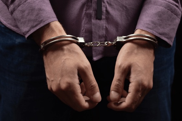 businessman-handcuffs-arrested-financial-fraud-600nw-2467324329